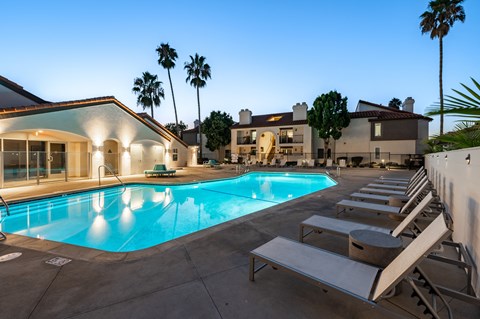 the swimming pool at the resort style clubhouse at night